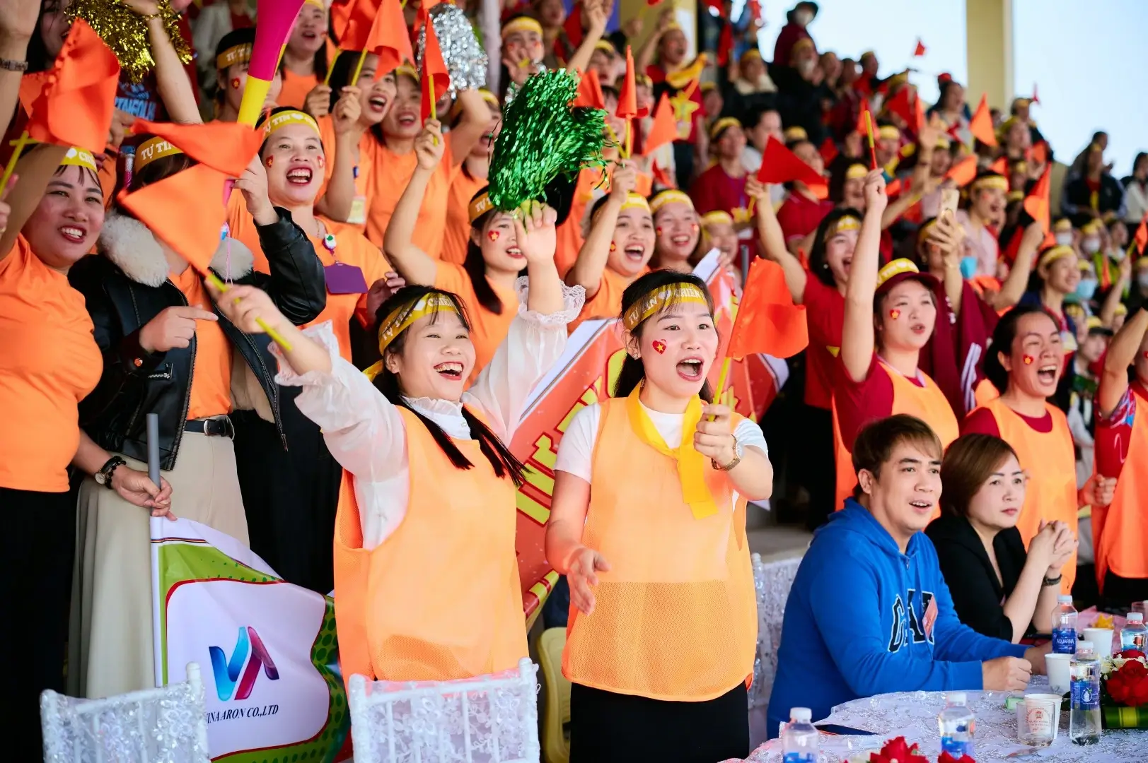 Supporters cheer passionately alongside the athletes.